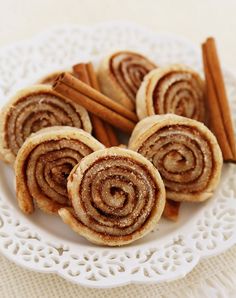 cinnamon rolls on a plate with cinnamon sticks