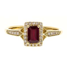 a gold ring with a red stone surrounded by diamonds