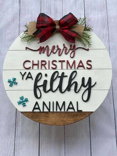 a wooden sign that says merry christmas ya filthy animal