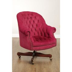 a pink office chair sitting on top of a hard wood floor