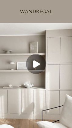 a living room with white furniture and shelves