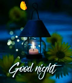 a candle is lit in a glass lantern with the words good night written on it