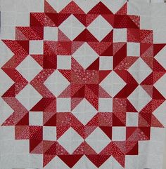 a red and white quilt with squares on it