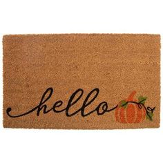 a door mat with the word hello written in cursive writing and an orange pumpkin