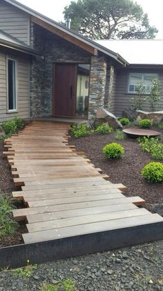 a wooden walkway in front of a house