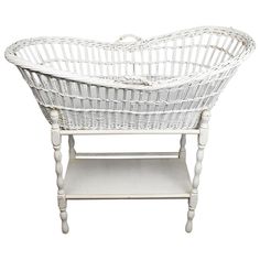 a white wicker basket sitting on top of a shelf