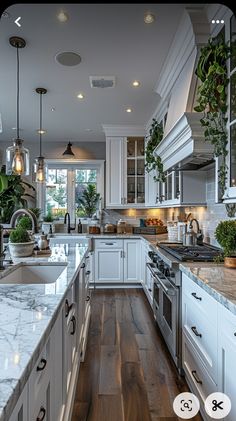 a large kitchen with white cabinets and marble counter tops, along with wooden floors that match the hardwood flooring