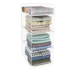 a stack of folded towels and blankets in a white wire basket on a white background