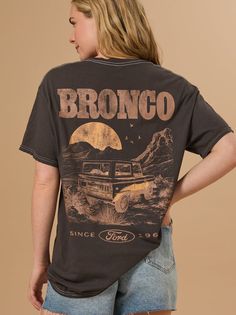 Rev up your style with the Ford Bronco Graphic Tee. Featuring a classic Bronco design, this tee offers a vintage vibe perfect for any adventurer. Ford Bronco Apparel, Ford Bronco Tshirt, Retro Crew Neck T-shirt For Outdoor, Retro Outdoor Graphic Print T-shirt, Retro Graphic Print T-shirt For Outdoor, Vintage Adventure Graphic T-shirt, Vintage Graphic Print T-shirt For Adventure, Vintage Short Sleeve T-shirt For Adventure, Vintage Crew Neck Tops For Adventure