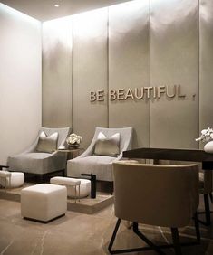 a room with chairs, tables and stools in it that says be beautiful on the wall