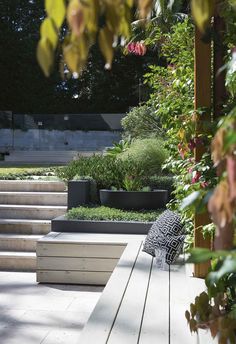 a wooden bench sitting in the middle of a garden