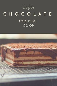 a chocolate mousse cake on a cooling rack with the words triple chocolate mousse cake above it