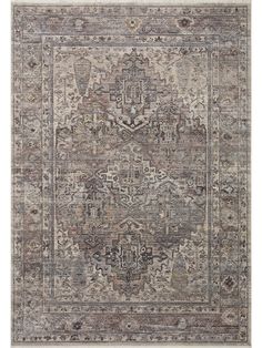 an area rug with various colors and patterns on the floor, including greys, browns, and beiges