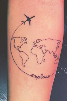 an airplane flying over the earth tattoo on someone's arm that reads, explore