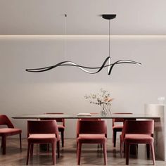 a dining room table with red chairs around it