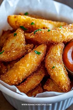 some fried food in a white bowl with ketchup