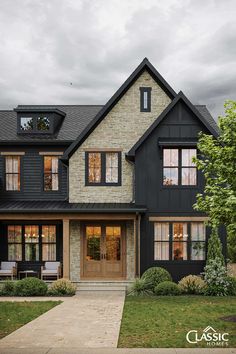 Partial house exterior in dark nearly black board and batten, stone accent and front door, porch beams and details in stained wood. Black House, Modern Farmhouse, White House, Front Door, Decor Ideas, Farmhouse, Trim, Exterior, Black And White