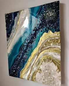 an abstract painting with blue, gold and white colors