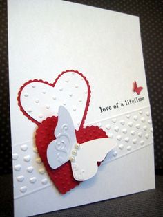 a close up of a greeting card with a heart and butterfly on the front side