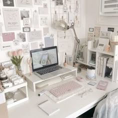 a laptop computer sitting on top of a white desk