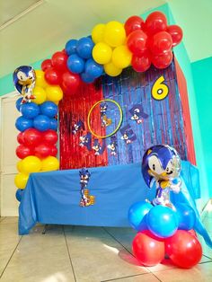 balloon arch for sonic the hedgehog birthday party with balloons and streamers on floor