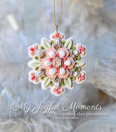 an ornament hanging from a tree with beads on it's sides and the words, my joyful moments handcrafted clay ornaments by kay miller