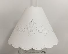 a white lamp shade sitting on top of a table