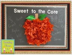 an apple made out of red tissue paper on a chalkboard with the words sweet to the core