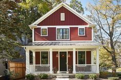 a red and white house with a flag on the front porch