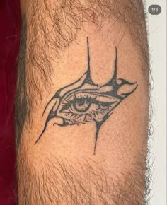 a man's leg with a tattoo on it that has an eye in the middle