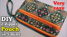 the zipper pouch is made from two different fabrics and has an orange lining on it