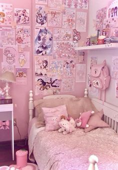 a bedroom decorated in pink and white with lots of pictures on the wall above the bed