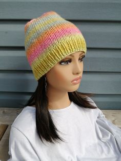 a mannequin head wearing a multicolored hat