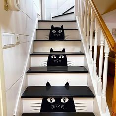 two black cats painted on the steps of a house