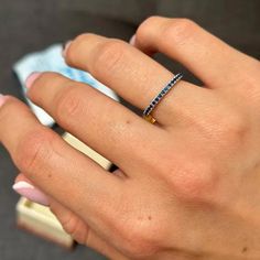 a woman's hand with a diamond ring on it