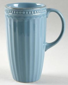 a light blue mug with beading on the rim is shown in front of a white background