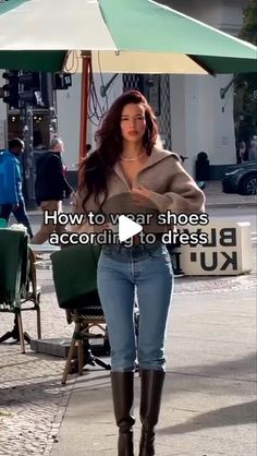 a woman is walking down the street with an umbrella over her head and text that reads, how to wear boots according to dress