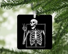 a skeleton ornament hanging from a christmas tree