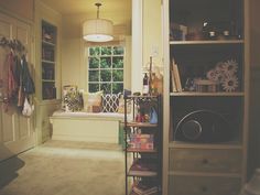 an open door leading to a living room with bookshelves and other items on the shelves