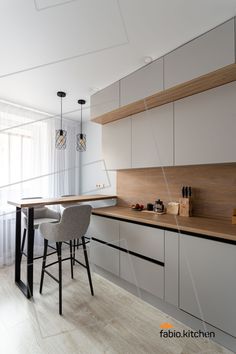 the kitchen is clean and ready to be used for dinner or breakfast time, as well as bar stools