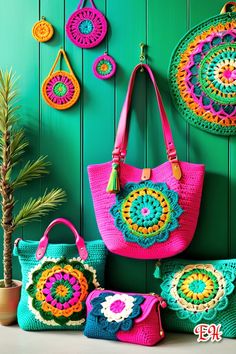 colorful crocheted purses and handbags are displayed against a green painted wall