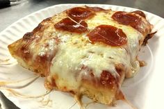 a slice of pepperoni pizza on a paper plate