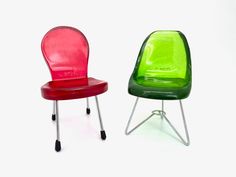 two plastic chairs sitting next to each other