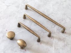 four different types of handles and knobs on a marble surface