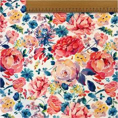 a ruler is next to a floral print fabric