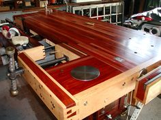 a large wooden table being worked on in a shop