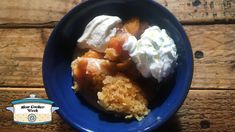 a blue bowl filled with fruit and whipped cream