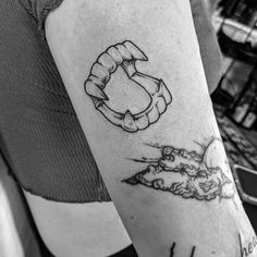 a black and white photo of a person's arm with a tattoo on it