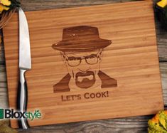 a wooden cutting board with an image of a man wearing a hat and glasses