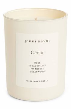 a white candle with the words cedar on it